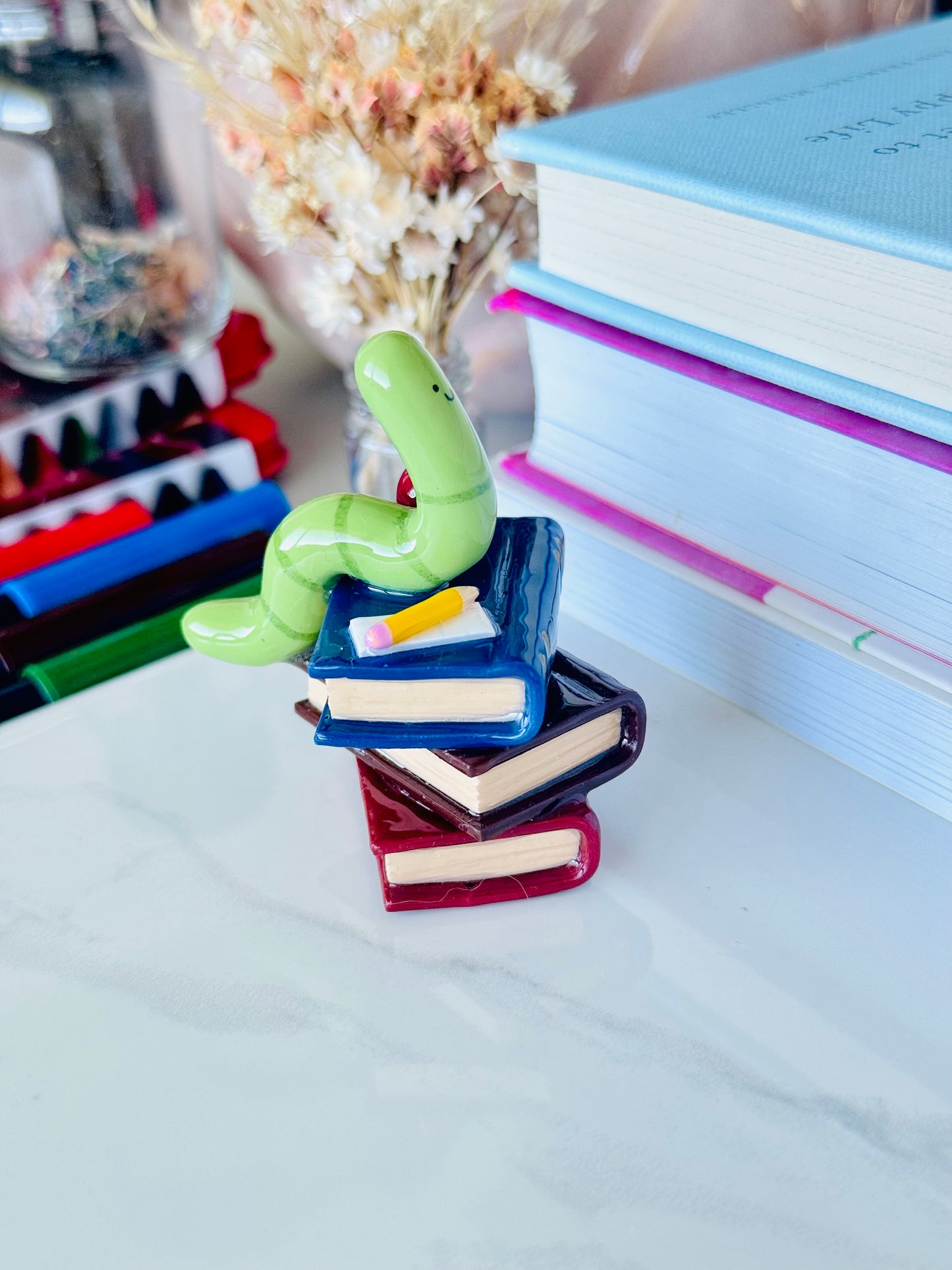 Wrigley the Worm desk friend handmade polymer clay figurine with books, apple, pen, and paper for desk décor