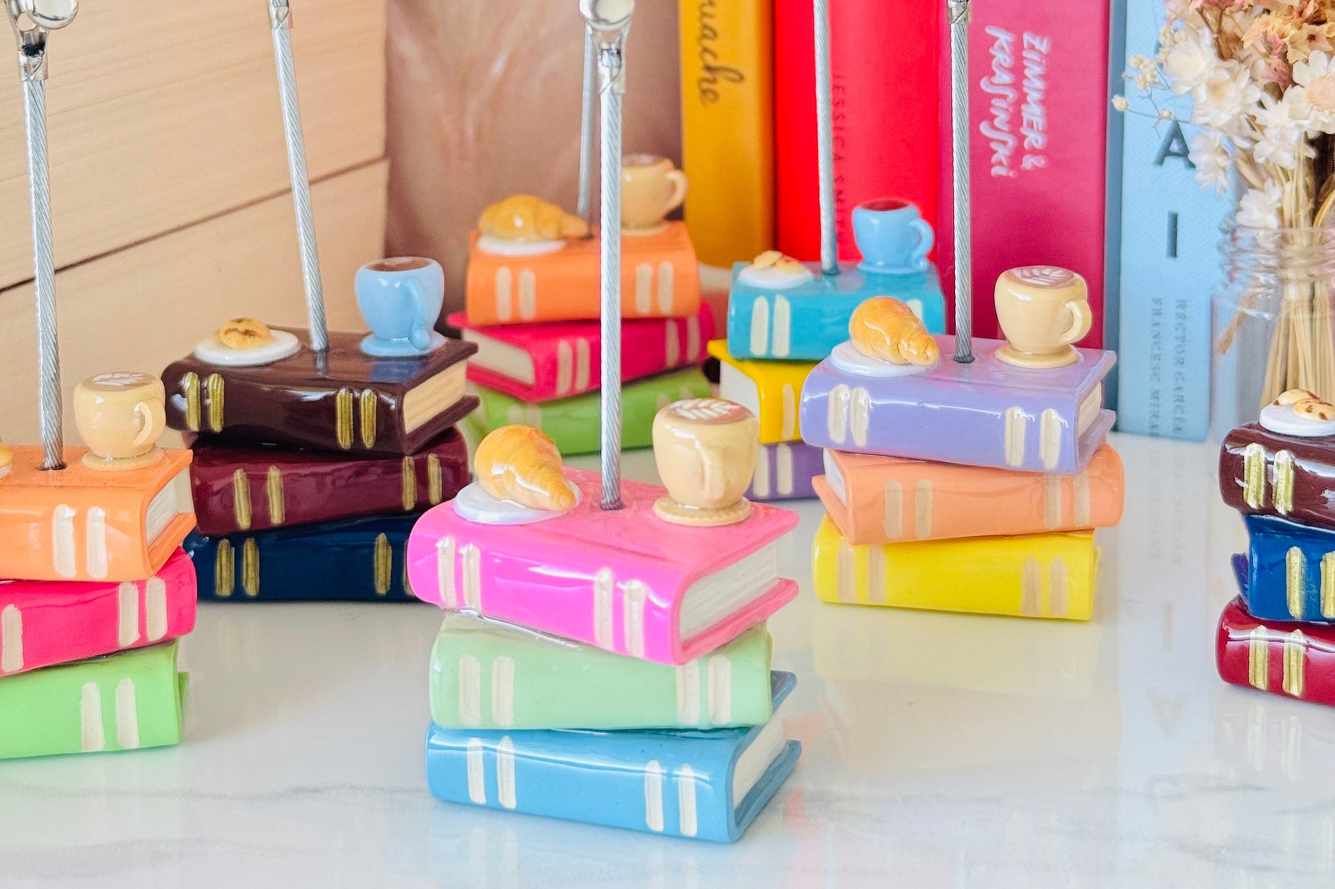 Colorful book-shaped photo holder with a 'Clip Photo Here' sign on a white surface.