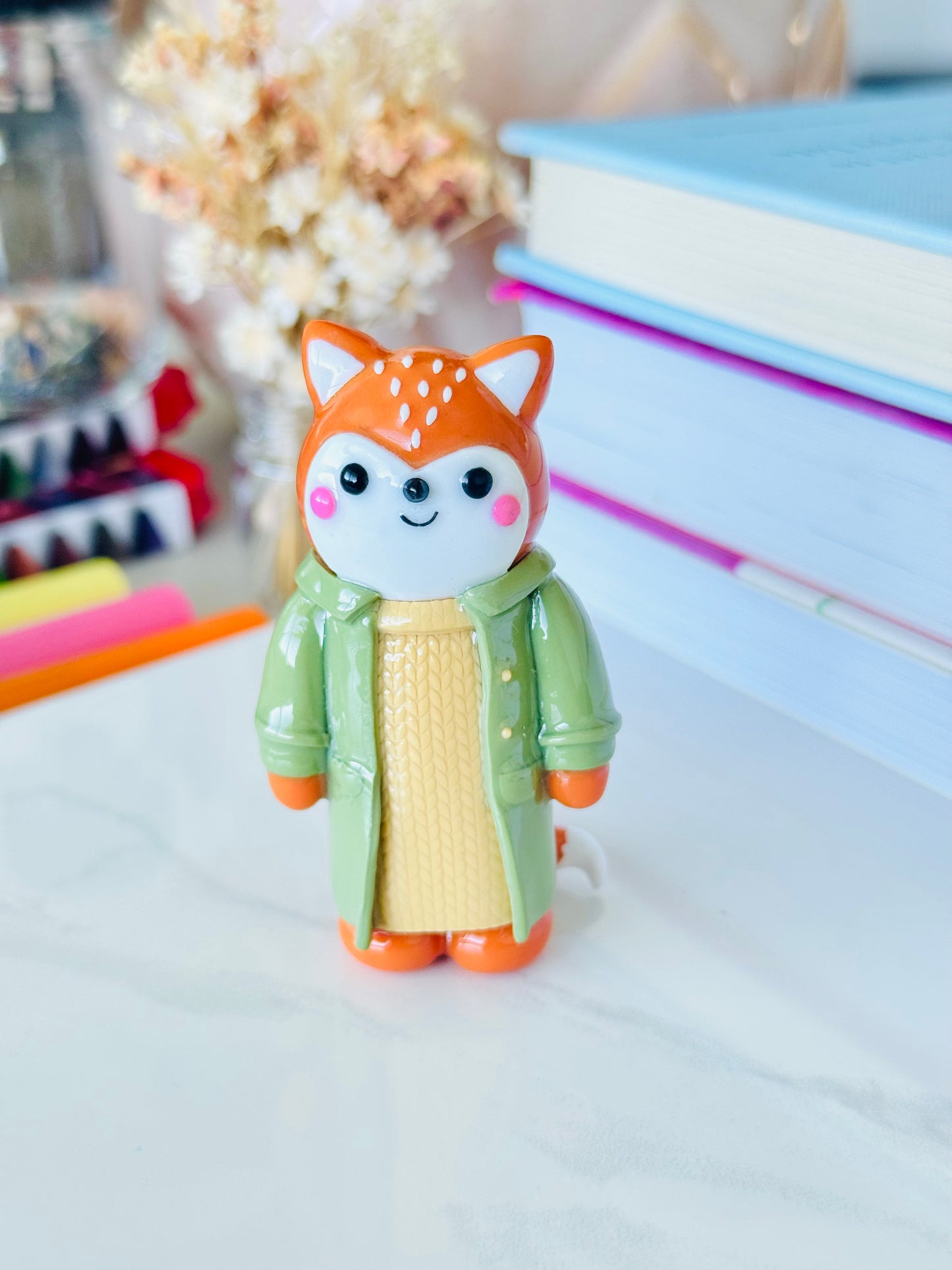 Toy figure of a fox in a green coat 