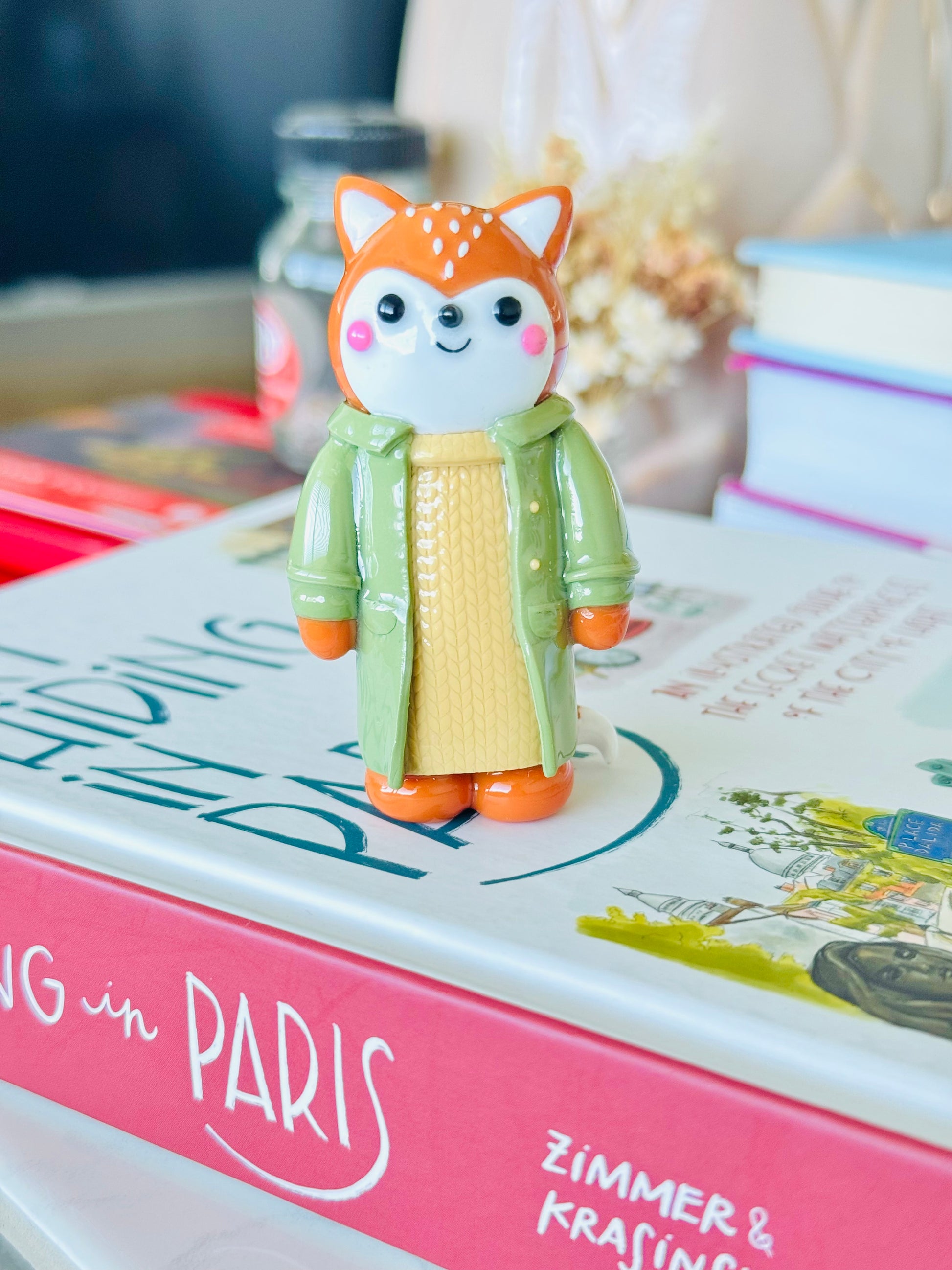 Small figurine of a fox in a green coat 