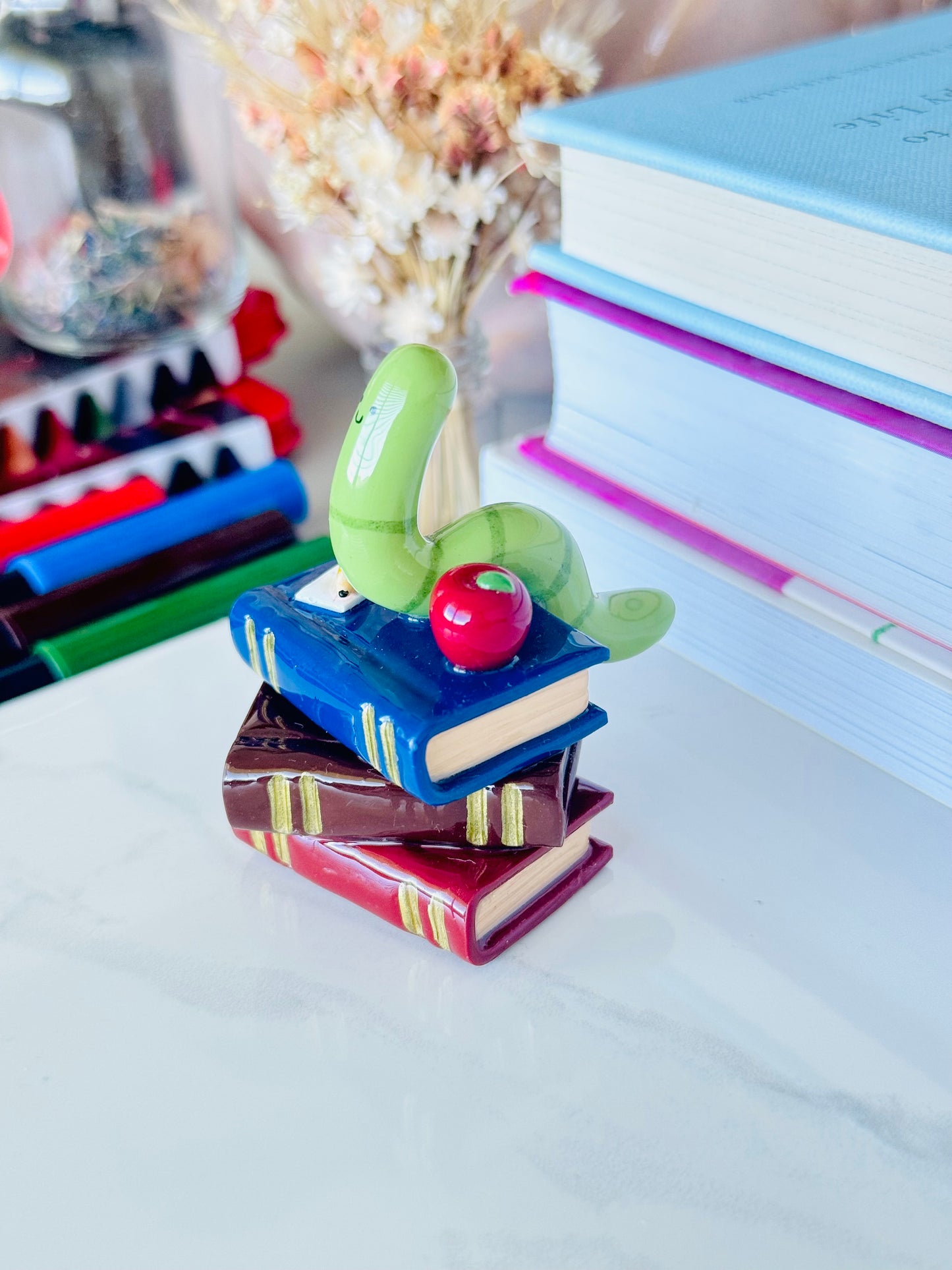 Wrigley the Worm desk friend handmade polymer clay figurine with books, apple, pen, and paper for desk décor